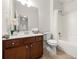 Clean bathroom featuring a vanity, toilet, and shower-tub combination with modern fixtures at 5484 Stone Cove Sw Dr, Atlanta, GA 30331