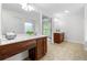 Bright bathroom features double sink vanity, tiled floors and white paint at 5484 Stone Cove Sw Dr, Atlanta, GA 30331