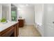 Bathroom with double sinks, tile floor, shower, and soaking tub at 5484 Stone Cove Sw Dr, Atlanta, GA 30331