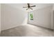 Spacious bedroom with neutral carpet and a window offering views of the well-maintained backyard at 5484 Stone Cove Sw Dr, Atlanta, GA 30331