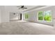 Large bedroom featuring neutral carpeting, ceiling fan, and natural light at 5484 Stone Cove Sw Dr, Atlanta, GA 30331