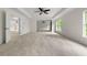 Expansive carpeted bedroom features ceiling fan and open layout at 5484 Stone Cove Sw Dr, Atlanta, GA 30331