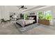 Staged primary bedroom features a ceiling fan and multiple windows at 5484 Stone Cove Sw Dr, Atlanta, GA 30331