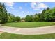 Beautiful community green space featuring a well-maintained lawn and tall shady trees at 5484 Stone Cove Sw Dr, Atlanta, GA 30331