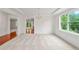 Bright dining room with large window, wainscoting, and an open view of the kitchen at 5484 Stone Cove Sw Dr, Atlanta, GA 30331