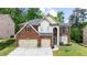 Beautiful two-story brick home with a well-manicured lawn and a three-car garage at 5484 Stone Cove Sw Dr, Atlanta, GA 30331