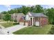 Beautiful two-story brick home with a well-manicured lawn and three car garage at 5484 Stone Cove Sw Dr, Atlanta, GA 30331
