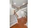 Grand foyer with hardwood floors, staircase with wooden railing, and elegant lighting at 5484 Stone Cove Sw Dr, Atlanta, GA 30331
