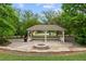 Community gazebo surrounded by trees, and a brick fire pit, perfect for outdoor gatherings at 5484 Stone Cove Sw Dr, Atlanta, GA 30331