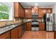 A modern kitchen boasts stainless steel appliances, granite countertops, and wooden cabinets at 5484 Stone Cove Sw Dr, Atlanta, GA 30331