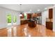 A spacious kitchen boasts wooden cabinets, stainless steel appliances, a kitchen island, and hardwood floors at 5484 Stone Cove Sw Dr, Atlanta, GA 30331