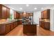 A kitchen is equipped with wooden cabinets, stainless steel appliances, a kitchen island, and hardwood floors at 5484 Stone Cove Sw Dr, Atlanta, GA 30331