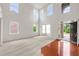Spacious living room featuring soaring ceilings and abundant natural light from large windows at 5484 Stone Cove Sw Dr, Atlanta, GA 30331