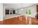 A cozy living room with hardwood floors, built-in shelves, fireplace, and outdoor access at 5484 Stone Cove Sw Dr, Atlanta, GA 30331