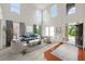 Bright, open living room featuring high ceilings, large windows, and stylish decor at 5484 Stone Cove Sw Dr, Atlanta, GA 30331