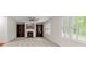 A bright living room boasts carpeted floors, built-in shelves, a fireplace, and lots of windows at 5484 Stone Cove Sw Dr, Atlanta, GA 30331