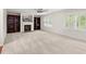 A bright living room features carpeted floors, built-in shelves, and a fireplace at 5484 Stone Cove Sw Dr, Atlanta, GA 30331
