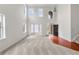 Sunlit living room featuring large windows, hardwood floors, and neutral walls at 5484 Stone Cove Sw Dr, Atlanta, GA 30331