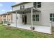 Open patio area for outdoor enjoyment with a well-maintained yard and rear house elevation at 5484 Stone Cove Sw Dr, Atlanta, GA 30331