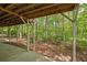 Back porch of house with wood support posts and view of wooded area at 7320 Oak Arms Dr, Villa Rica, GA 30180