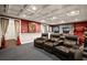 Home theater room featuring plush seating, tray ceilings, and recessed lights at 7320 Oak Arms Dr, Villa Rica, GA 30180