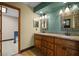 Bathroom featuring double sinks, granite counters, and beautiful, decorative framed mirrors at 7320 Oak Arms Dr, Villa Rica, GA 30180