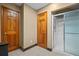 Bathroom with a glass-enclosed shower, neutral walls, and two wooden doors at 7320 Oak Arms Dr, Villa Rica, GA 30180