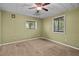 The bedroom features carpet, ceiling fan, and natural light from dual windows at 7320 Oak Arms Dr, Villa Rica, GA 30180