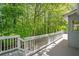 Deck of house with white railing and view of wooded area at 7320 Oak Arms Dr, Villa Rica, GA 30180