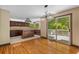 Bright dining area with hardwood floors, sliding glass doors leading to a deck, and a view of the kitchen at 7320 Oak Arms Dr, Villa Rica, GA 30180