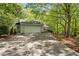 Charming home featuring a two-car garage, a long driveway and a wooded lot at 7320 Oak Arms Dr, Villa Rica, GA 30180