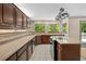 Kitchen featuring tile floors, granite countertops, dark wood cabinets and stainless steel appliances at 7320 Oak Arms Dr, Villa Rica, GA 30180
