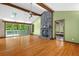 Bright living room with hardwood floors, stone fireplace, vaulted ceiling, and access to a deck at 7320 Oak Arms Dr, Villa Rica, GA 30180