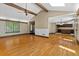 Spacious living room featuring hardwood floors, large windows, and vaulted ceilings with wooden beams at 7320 Oak Arms Dr, Villa Rica, GA 30180