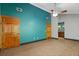 A main bedroom featuring an teal accent wall and two wooden doors, with an ensuite bathroom at 7320 Oak Arms Dr, Villa Rica, GA 30180