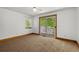 Bedroom with carpet, a ceiling fan, and sliding glass doors to a private deck at 7320 Oak Arms Dr, Villa Rica, GA 30180