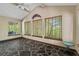 Sunroom with flagstone floors and multiple windows bringing the outdoors in at 7320 Oak Arms Dr, Villa Rica, GA 30180