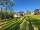 Large, fenced-in backyard with a covered deck and mature trees at 1021 Liberty Springs Dr, Woodstock, GA 30188