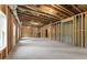 Unfinished basement featuring concrete floor, natural light and exposed studs at 1021 Liberty Springs Dr, Woodstock, GA 30188
