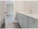 Bright bathroom featuring wood-look floors, gray vanity, and access to the shower and bedroom at 1021 Liberty Springs Dr, Woodstock, GA 30188