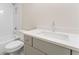 Bright bathroom with white subway tiles, tub, and gray vanity at 1021 Liberty Springs Dr, Woodstock, GA 30188