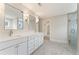 Modern bathroom with double vanity, marble-look floor, and large glass enclosed shower at 1021 Liberty Springs Dr, Woodstock, GA 30188