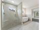 Bright bathroom with glass shower, modern soaking tub, and elegant tile at 1021 Liberty Springs Dr, Woodstock, GA 30188