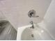 Close up of sleek bathtub fixtures with white tiled wall at 1021 Liberty Springs Dr, Woodstock, GA 30188