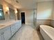 Elegant bathroom featuring double vanity, freestanding tub, and glass shower at 1021 Liberty Springs Dr, Woodstock, GA 30188