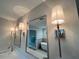 Bright bathroom with sleek vanity, framed mirrors, stylish sconces, and a modern bathtub in the background at 1021 Liberty Springs Dr, Woodstock, GA 30188