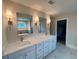Dual sink vanity with modern fixtures and bright lighting in this bathroom at 1021 Liberty Springs Dr, Woodstock, GA 30188