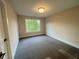 Bright bedroom with large window and neutral carpet, perfect for relaxation at 1021 Liberty Springs Dr, Woodstock, GA 30188