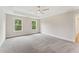 Expansive bedroom features tray ceiling, ceiling fan, neutral paint and carpet, and large windows at 1021 Liberty Springs Dr, Woodstock, GA 30188