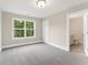 Cozy bedroom with carpet, natural light, and an en-suite bathroom at 1021 Liberty Springs Dr, Woodstock, GA 30188